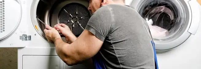 Dryer repair technician fixing a clothes dryer drum in Stockton, CA