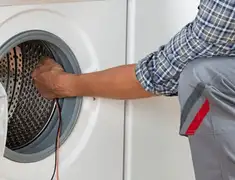 Dryer repair technician diagnosing and servicing a clothes dryer in Stockton, CA
