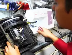 Vacuum repair technician servicing internal components on a workbench in Stockton, CA