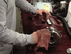 Vacuum repair technician cleaning and servicing a vacuum motor in Stockton, CA