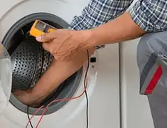 Washing machine repair technician testing a front-load washer with diagnostic tools in Stockton, CA